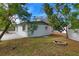 House exterior with backyard, fire pit, and trees at 6699 78Th N Ave, Pinellas Park, FL 33781