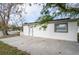 Renovated home with a large concrete patio and a single car driveway at 6699 78Th N Ave, Pinellas Park, FL 33781