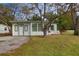 Newly renovated home exterior, featuring a white facade and updated landscaping at 6699 78Th N Ave, Pinellas Park, FL 33781