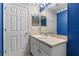Bright bathroom with single sink vanity and blue walls at 6944 Towne Lake Rd, Riverview, FL 33578