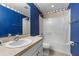 Bathroom with blue walls, shower/tub combo, and single sink vanity at 6944 Towne Lake Rd, Riverview, FL 33578