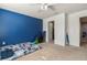 bedroom with blue accent wall, carpet flooring, and ample closet space at 6944 Towne Lake Rd, Riverview, FL 33578