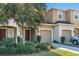 Front view of two story townhome with double garage at 6944 Towne Lake Rd, Riverview, FL 33578