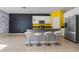 Kitchen with island, stainless steel appliances, and yellow accent wall at 6944 Towne Lake Rd, Riverview, FL 33578