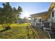 Sunny backyard with grassy lawn and mature trees at 718 40Th Ne Ave, St Petersburg, FL 33703