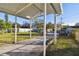 Covered patio overlooks a spacious backyard with grassy lawn at 718 40Th Ne Ave, St Petersburg, FL 33703