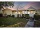 Charming yellow house with landscaped lawn and walkway at 718 40Th Ne Ave, St Petersburg, FL 33703