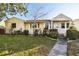 Charming yellow house with landscaped lawn and walkway at 718 40Th Ne Ave, St Petersburg, FL 33703