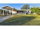 Charming yellow house with a covered patio and well-maintained lawn at 718 40Th Ne Ave, St Petersburg, FL 33703