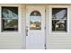 White front door with arched window and sidelights at 718 40Th Ne Ave, St Petersburg, FL 33703