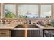 Farmhouse style sink with hexagon tile backsplash and view to backyard at 718 40Th Ne Ave, St Petersburg, FL 33703