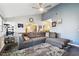 Spacious living room with gray sectional sofa and ceiling fan at 718 40Th Ne Ave, St Petersburg, FL 33703
