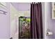 Shower stall with purple walls and a patterned shower curtain at 718 40Th Ne Ave, St Petersburg, FL 33703