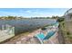 Relaxing patio overlooking a lake, featuring lounge chairs and a fire pit at 7643 Vienna Ln, Port Richey, FL 34668