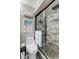 Updated bathroom with a walk-in shower and marble tile at 7643 Vienna Ln, Port Richey, FL 34668