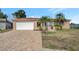 Single-story home with a paved driveway and well-manicured lawn at 7643 Vienna Ln, Port Richey, FL 34668