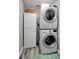Stackable washer and dryer in a well-lit laundry room at 7643 Vienna Ln, Port Richey, FL 34668