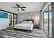 Bright bedroom with a king-size bed and sliding barn door at 7643 Vienna Ln, Port Richey, FL 34668