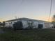 Single-story house with light-colored walls, a garage, and a grassy yard at 7824 3Rd S Ave, St Petersburg, FL 33707