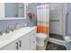 Updated bathroom with a walk-in shower and white vanity at 8174 Terrace Garden N Dr # 110, St Petersburg, FL 33709