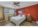 Bedroom with a queen bed and red accent wall at 8174 Terrace Garden N Dr # 110, St Petersburg, FL 33709