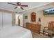 Bright bedroom with a dresser, chair, and view into another room at 8174 Terrace Garden N Dr # 110, St Petersburg, FL 33709