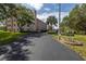 Condo building entrance with lush landscaping at 8174 Terrace Garden N Dr # 110, St Petersburg, FL 33709