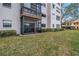 Exterior view showing condo patio and lawn at 8174 Terrace Garden N Dr # 110, St Petersburg, FL 33709
