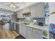 Kitchen with stainless steel appliances and grey cabinets at 8174 Terrace Garden N Dr # 110, St Petersburg, FL 33709
