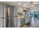 Kitchen with stainless steel appliances and grey cabinets at 8174 Terrace Garden N Dr # 110, St Petersburg, FL 33709