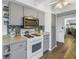 White stove and grey cabinets in this galley kitchen at 8174 Terrace Garden N Dr # 110, St Petersburg, FL 33709