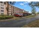 Condo parking lot with covered spaces and landscaping at 8174 Terrace Garden N Dr # 110, St Petersburg, FL 33709