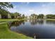 Landscaped pond with fountain, reflecting building in background at 8174 Terrace Garden N Dr # 110, St Petersburg, FL 33709