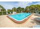 Community pool with lounge chairs and surrounding landscaping at 8174 Terrace Garden N Dr # 110, St Petersburg, FL 33709