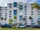 Condo building with palm trees and parking at 855 Bayway Blvd # 606, Clearwater, FL 33767