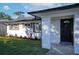 Front entrance of a renovated ranch home with black door at 8577 79Th Ave, Seminole, FL 33777