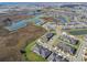 Aerial view of a new community with houses, lakes, and conservation areas at 10374 Echo Dock Loop, San Antonio, FL 33576