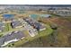 Aerial view highlighting a residential area with houses near a lake at 10374 Echo Dock Loop, San Antonio, FL 33576