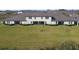 Rear view of a townhome with a large grassy yard at 10374 Echo Dock Loop, San Antonio, FL 33576