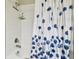 Bathroom with white tiled shower and blue shower curtain at 10374 Echo Dock Loop, San Antonio, FL 33576