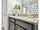 Bathroom with granite countertop, dark brown vanity, and a shower at 10374 Echo Dock Loop, San Antonio, FL 33576