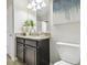 Bathroom with granite countertop, dark brown vanity, and white toilet at 10374 Echo Dock Loop, San Antonio, FL 33576