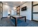 Billiards room with pool table, modern light fixture and view into community room at 10374 Echo Dock Loop, San Antonio, FL 33576