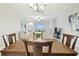 Bright dining room with wooden table, view into living room and sliding glass doors at 10374 Echo Dock Loop, San Antonio, FL 33576