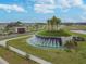Community entrance features a circular fountain and palm trees at 10374 Echo Dock Loop, San Antonio, FL 33576