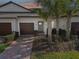 Two-car garage and light gray front door at 10374 Echo Dock Loop, San Antonio, FL 33576