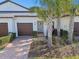 Charming home exterior featuring a two-car garage and well-maintained landscaping at 10374 Echo Dock Loop, San Antonio, FL 33576