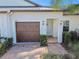 Well-maintained exterior with a two-car garage and attractive landscaping at 10374 Echo Dock Loop, San Antonio, FL 33576