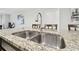 Close-up of kitchen sink with granite countertop and modern faucet at 10374 Echo Dock Loop, San Antonio, FL 33576