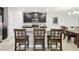 Modern kitchen with granite island, dark cabinets, and stainless steel appliances at 10374 Echo Dock Loop, San Antonio, FL 33576